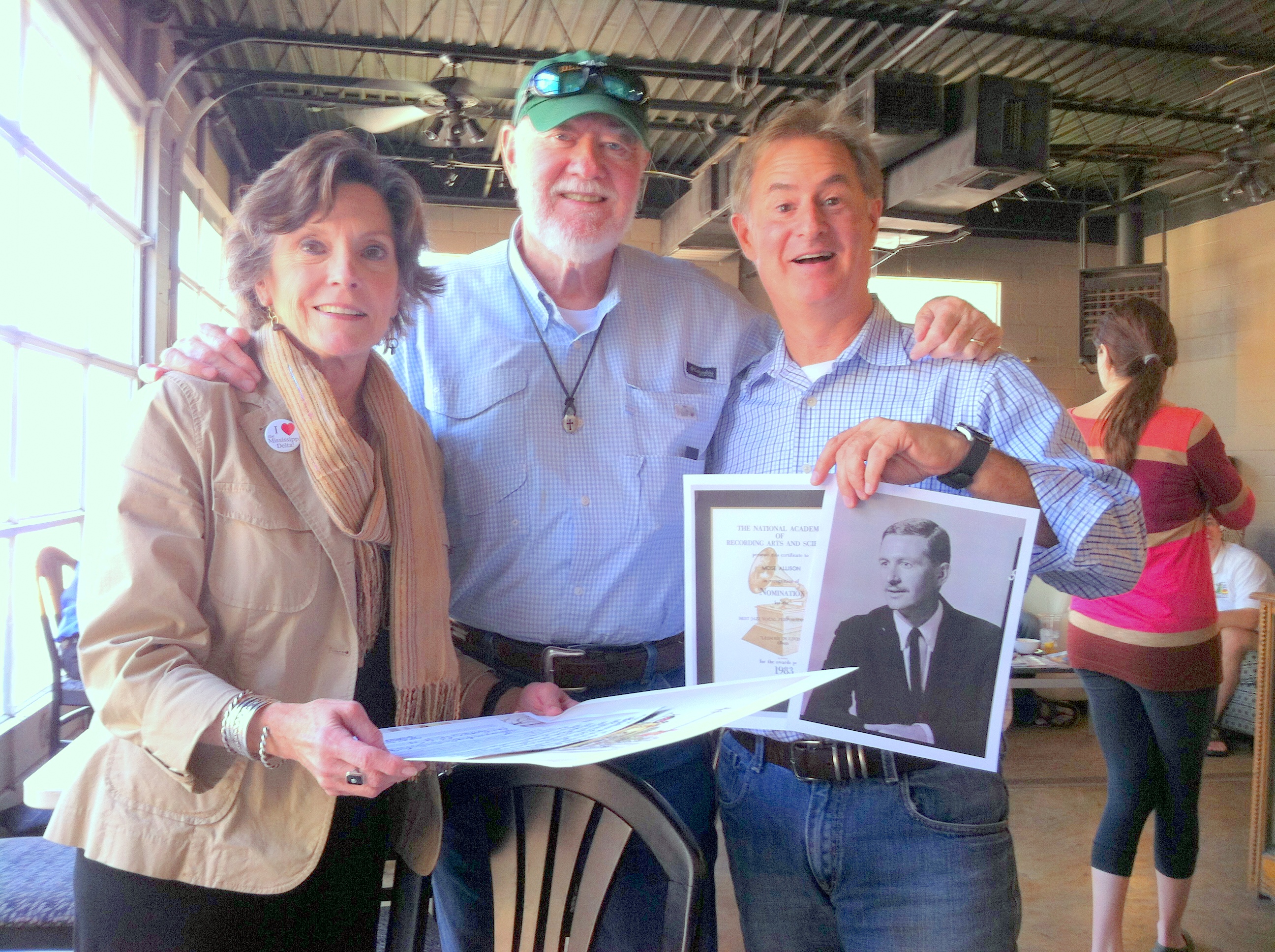 PHOTO: The DSU Delta Center's Lee Aylward, Henry Outlaw, and John Allison, holding a photograph of his father Mose Allison, who grew up in Tippo, Mississippi, in Tallahatchie County.  